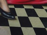 a painting of a woman ' s legs and shoes on a checkered floor