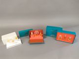four small boxes with different designs on them sitting on a table