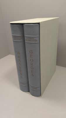 two books are stacked on top of each other on a table