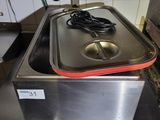 stainless steel counter top with a hot plate on top of it in a kitchen