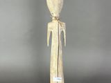 a wooden statue of a man with a hat on his head