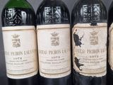 four bottles of wine are lined up on a table