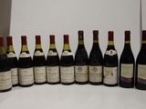 many bottles of wine lined up on a table