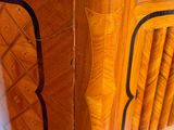 a close up of a wooden table with a vase on top