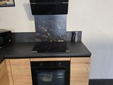 a kitchen with a stove, oven, microwave and toaster oven