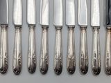 six knives and six knives on a table