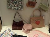 a table with many bags and purses on it