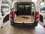 a white van with its doors open in a garage