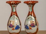 two vases that are sitting on a table