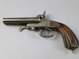 an old gun with a wooden handle on a white surface