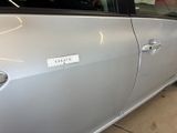 a silver car with a sticker on the side of it