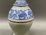 a blue and white vase sitting on a table
