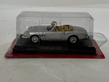 a silver model of a car in a glass case