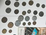 a lot of coins and a book on a table