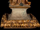 a statue of a woman sitting on top of a table