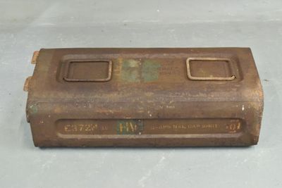 an old, rusted metal box sitting on top of a white surface