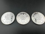 trois pièces d'argent, dont l'une représente une tête de lion et l'autre une tête de lion