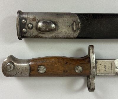 two knives are sitting next to each other on a white surface