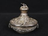 a silver plated box with a bird on top of it