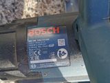 a close up of a bosch electric tool on a table