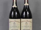 two bottles of red wine sitting on top of a glass table