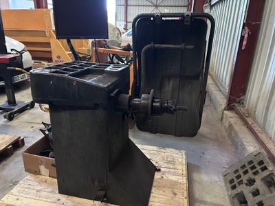 a black machine that is sitting on a pallet in a warehouse