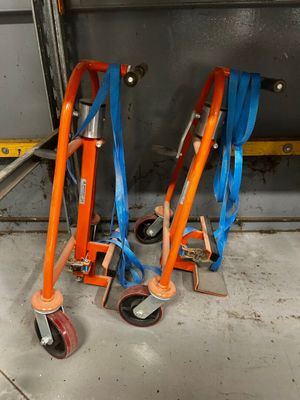 two orange and blue hand trucks that are on the floor