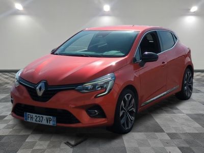 une voiture rouge est garée sur le sol en damier d'un garage