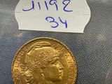 a close up of a gold coin with a label on it