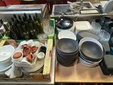 many plates and bowls sitting on a table in the kitchen