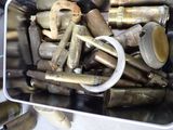 a metal container filled with various types of bullet shells