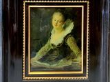 painting of a woman in a green dress sitting on a table