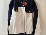 navy and white jacket hanging on a white curtain