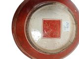 a red and white plate with a picture of a horse on it