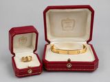 an image of a couple of red boxes with a gold bracelet