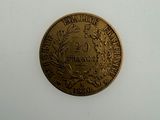 a close up of a gold coin on a white surface