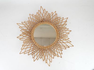 mirror in the shape of a sunburst on a white wall