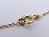 a close up of a gold chain on a white surface