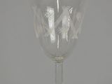 a glass goblet sitting on top of a table