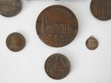a lot of coins that are on a white surface