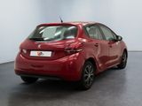 a red car is parked in a room with a white wall