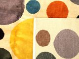 two pieces of fabric with different colors of dots on them