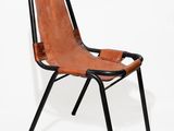 pair of leather and metal lounge chairs with black legs