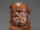 an image of a wooden mask with long hair and a beard