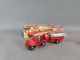 a red toy fire truck with a ladder and a box of candy