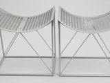 pair of white wicker stools with metal legs on a white background
