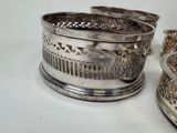 three silver dishes on a white table with a white background