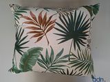 the pillow is made with a tropical leaf print on it