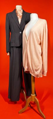 a mannequin and a suit on display on a mannequin stand