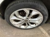 a close up of a tire on a car in a parking lot